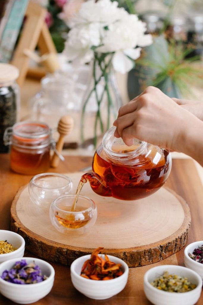 Pouring herbal teas into a small cup